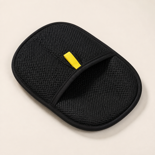 Black pet grooming mitt in clean studio setting